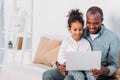 happy african american father and daughter using laptop Royalty Free Stock Photo