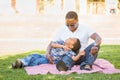 Happy African American Father and Mixed Race Son Picnicking At The Park Royalty Free Stock Photo