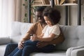 Happy African American father and preschool daughter using phone together Royalty Free Stock Photo