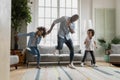 Happy african american father showing funny dancing moves to kids. Royalty Free Stock Photo