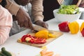 Happy african american father and son chopping vegetables in kitchen, slow motion Royalty Free Stock Photo