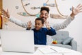 Happy african american father and son making fun while using laptop Royalty Free Stock Photo