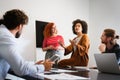 Happy african american female leader holding negotiations meeting with friendly diverse colleague Royalty Free Stock Photo