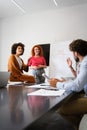 Happy african american female leader holding negotiations meeting with friendly diverse colleague Royalty Free Stock Photo