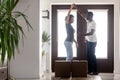 African couple dancing in hallway moving into new home