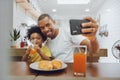 Happy African American Fther and little kid boy taking selfie with smartphone Royalty Free Stock Photo