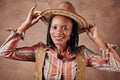 Happy african american girl cowboy with hat. brown background. portrait Royalty Free Stock Photo