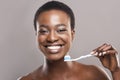 Happy african american girl holding toothbrush with applied toothpaste Royalty Free Stock Photo