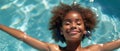 Happy African American Girl Joyfully Floating In A Swimming Pool On A Sunny Vacation