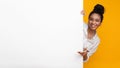 Happy African American Girl Looking Out Behind Blank Advertisement Board Royalty Free Stock Photo