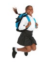 Happy African-American girl in school uniform jumping