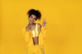 Happy african american girl wear stylish yellow clothes isolated on background