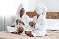 Happy women drinking coffee and talking after shower Royalty Free Stock Photo