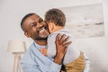 happy african american grandfather hugging adorable little grandchild Royalty Free Stock Photo