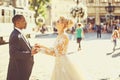 Happy african American groom and cute bride dancing on street Royalty Free Stock Photo