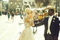 Happy african American groom and cute bride dancing on street Royalty Free Stock Photo