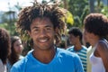 Happy african american guy with amazing hairstyle and friends outdoor Royalty Free Stock Photo