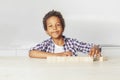 Happy african american kid small boy playing toys at home Royalty Free Stock Photo