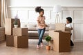 Happy african american kids playing near cardboard boxes. Royalty Free Stock Photo