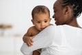 Happy African American lady hugging her cute child Royalty Free Stock Photo