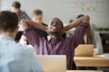 Happy african american leaning in chair in office Royalty Free Stock Photo