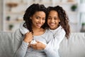 Happy african american little girl hugging her mother Royalty Free Stock Photo