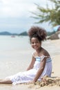 Happy african american Little girl play and  buried in sand on the beach Royalty Free Stock Photo