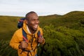 Happy african american male backpacker walking in nature