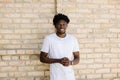 Happy African American man with dreadlocks walking down the street on a sunny day. Close-up portrait Royalty Free Stock Photo