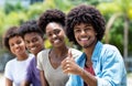 Happy african american man with group of young adults in line