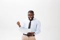 Happy African American man holding documaent paper over isolated white background with a surprise and shock face