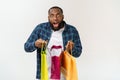 Happy african american man holding shopping bags on white background. Holidays concept Royalty Free Stock Photo