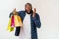 Happy african american man holding shopping bags on white background. Holidays concept Royalty Free Stock Photo