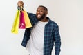 Happy african american man holding shopping bags on white background. Holidays concept Royalty Free Stock Photo