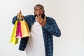 Happy african american man holding shopping bags on white background. Holidays concept Royalty Free Stock Photo