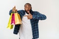 Happy african american man holding shopping bags on white background. Holidays concept Royalty Free Stock Photo