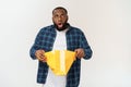 Happy african american man holding shopping bags on white background. Holidays concept Royalty Free Stock Photo