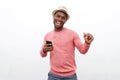 Happy african american man listening to music with earphones and mobile phone against white background Royalty Free Stock Photo