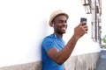 Happy african american man listening to music with mobile phone and earphones Royalty Free Stock Photo