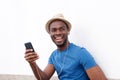 Happy african american man listening to music with smart phone and earphones Royalty Free Stock Photo