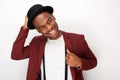 Happy african american man posing with blazer and hat against white background Royalty Free Stock Photo