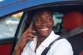 A happy African-American man is sitting in the car. Human emotions Royalty Free Stock Photo