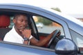 A happy African-American man is sitting in the car. Human emotions Royalty Free Stock Photo