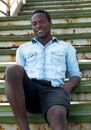 Happy african american man sitting on stairs outdoors Royalty Free Stock Photo