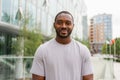 Happy african american man smiling outdoor. Portrait of young happy man on street in city. Cheerful joyful handsome Royalty Free Stock Photo