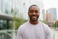 Happy african american man smiling outdoor. Portrait of young happy man on street in city. Cheerful joyful handsome Royalty Free Stock Photo