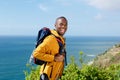 Happy african american man with walking backpack outdoors Royalty Free Stock Photo