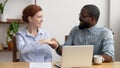 Happy African American manager shaking hand of client at workplace Royalty Free Stock Photo