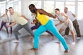 Happy African american man and group of international dancers training before big performance in dance class Royalty Free Stock Photo