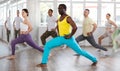 Happy African american man and group of international dancers training modern dance in dance class Royalty Free Stock Photo